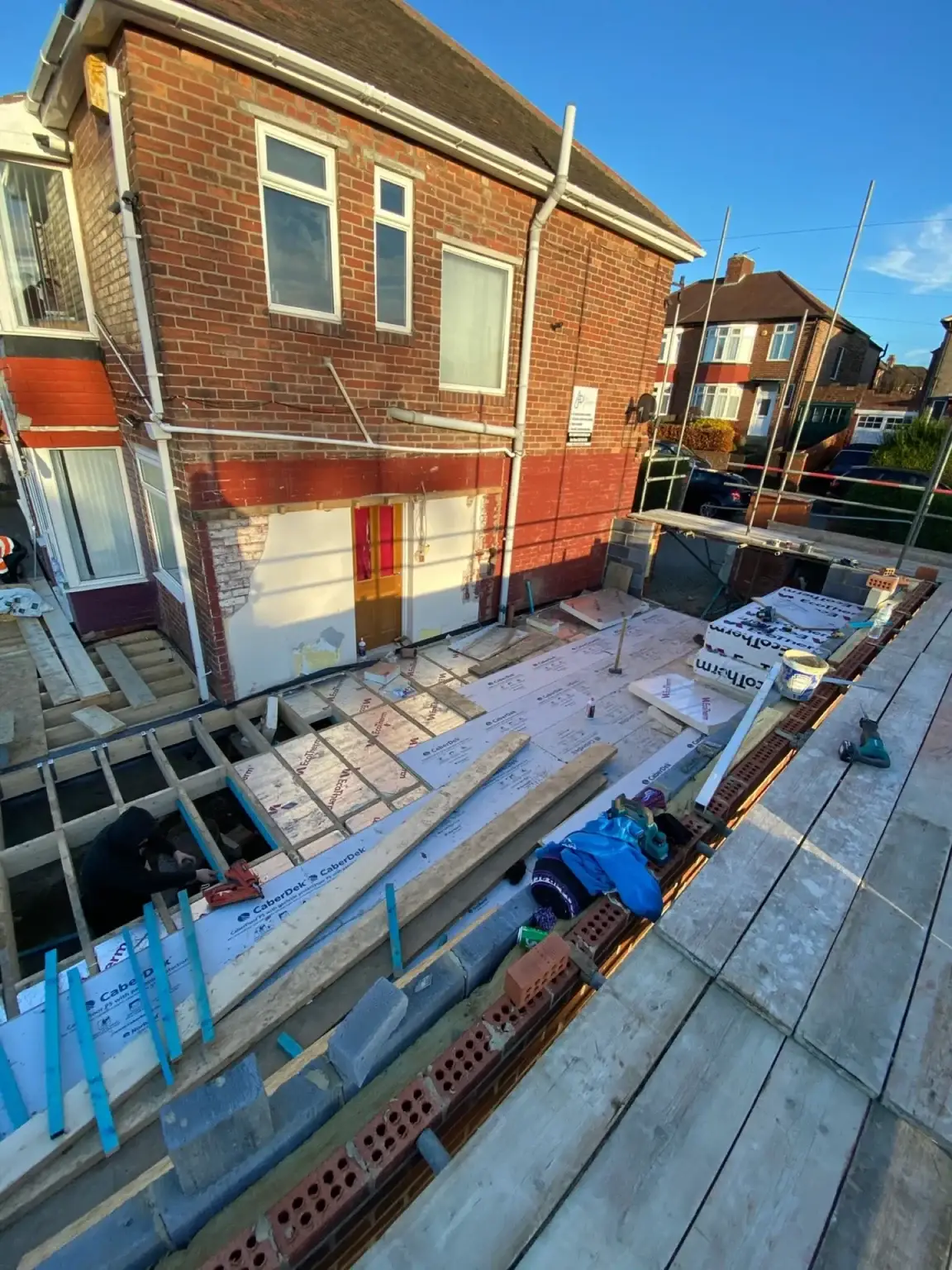 New timber floor and roof structure on a house extension, seen from the scaffold