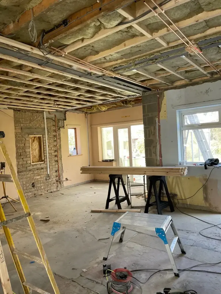 A room stripped back to the ceiling joists during a refurbishment