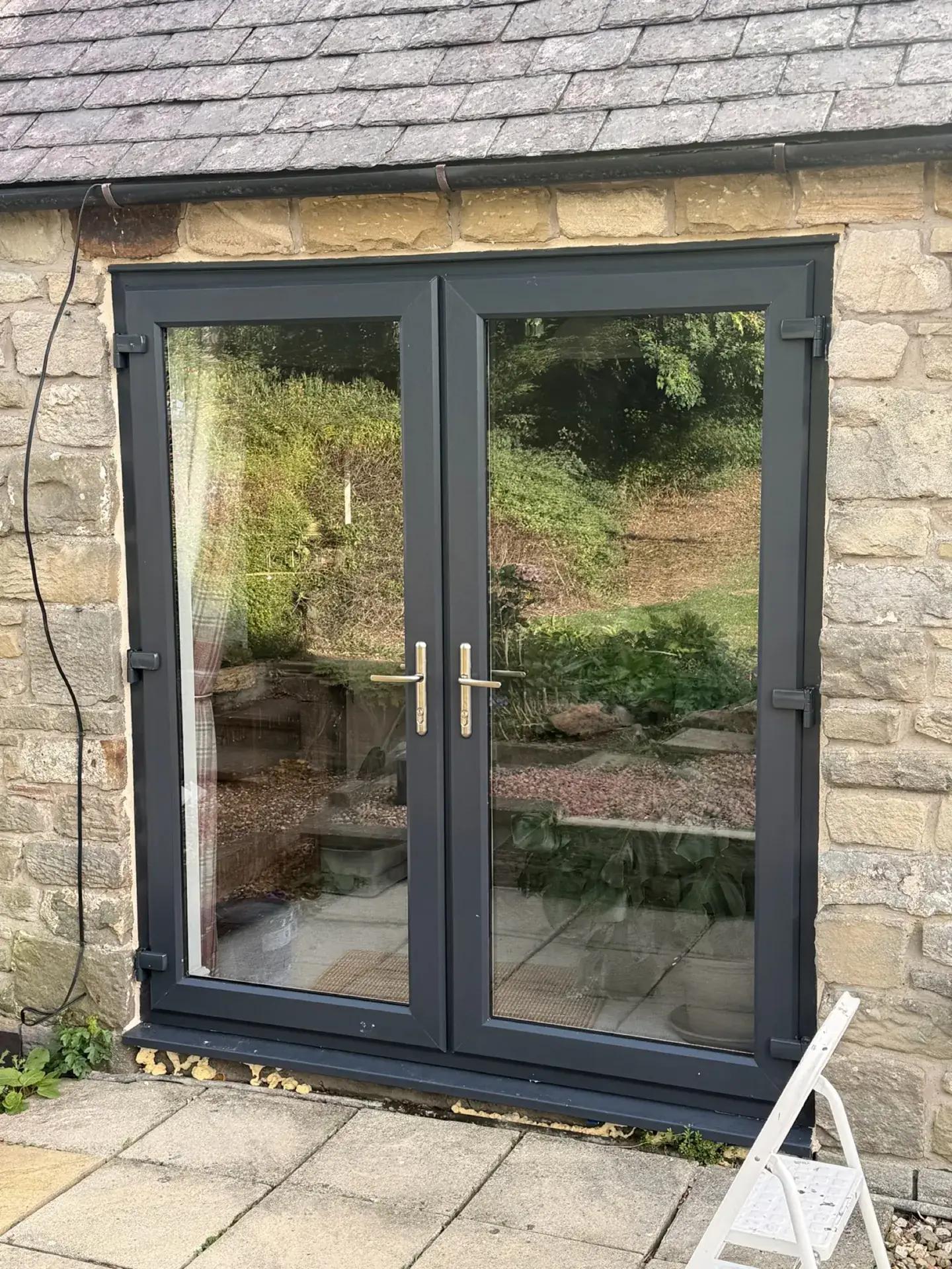 A third set of the anthracite grey French doors, in the same stone cottage