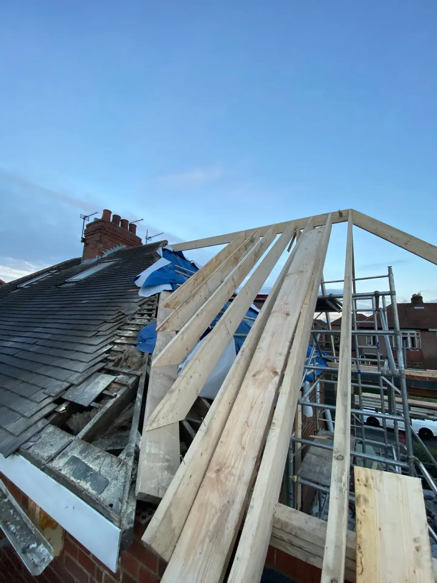 Rafters rising to a new ridge on a cut roof