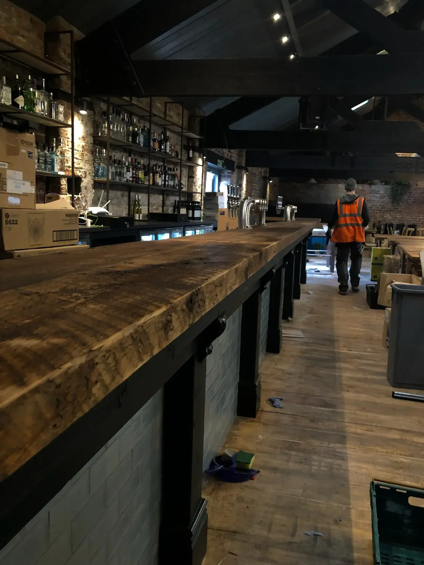 A long timber bar counter on black posts