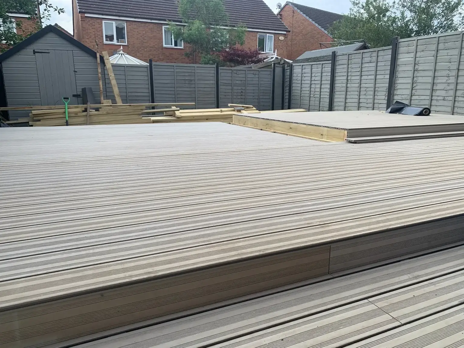 Grey composite decking boards laid across a new deck