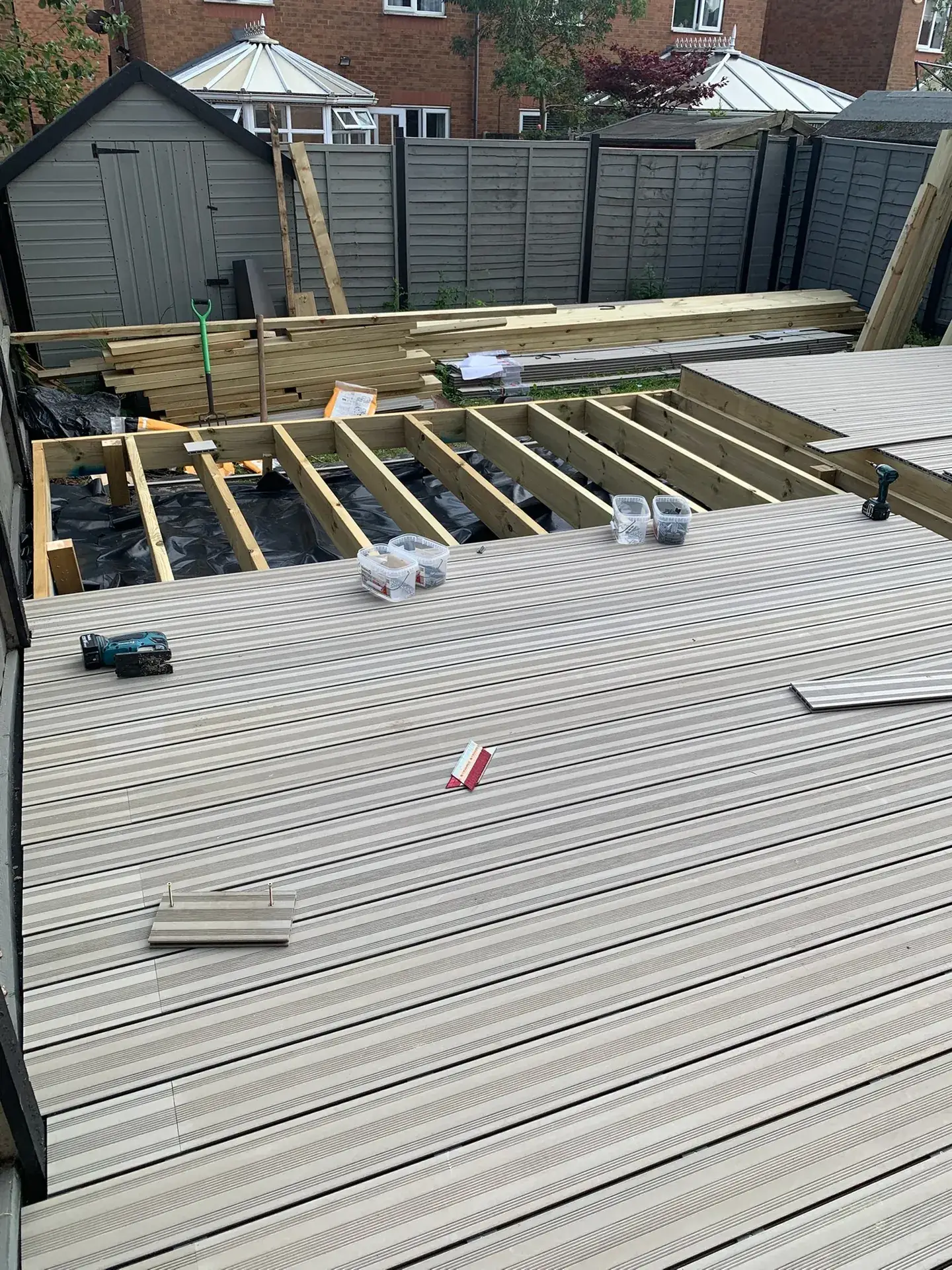 A treated timber deck subframe with the first composite boards going on