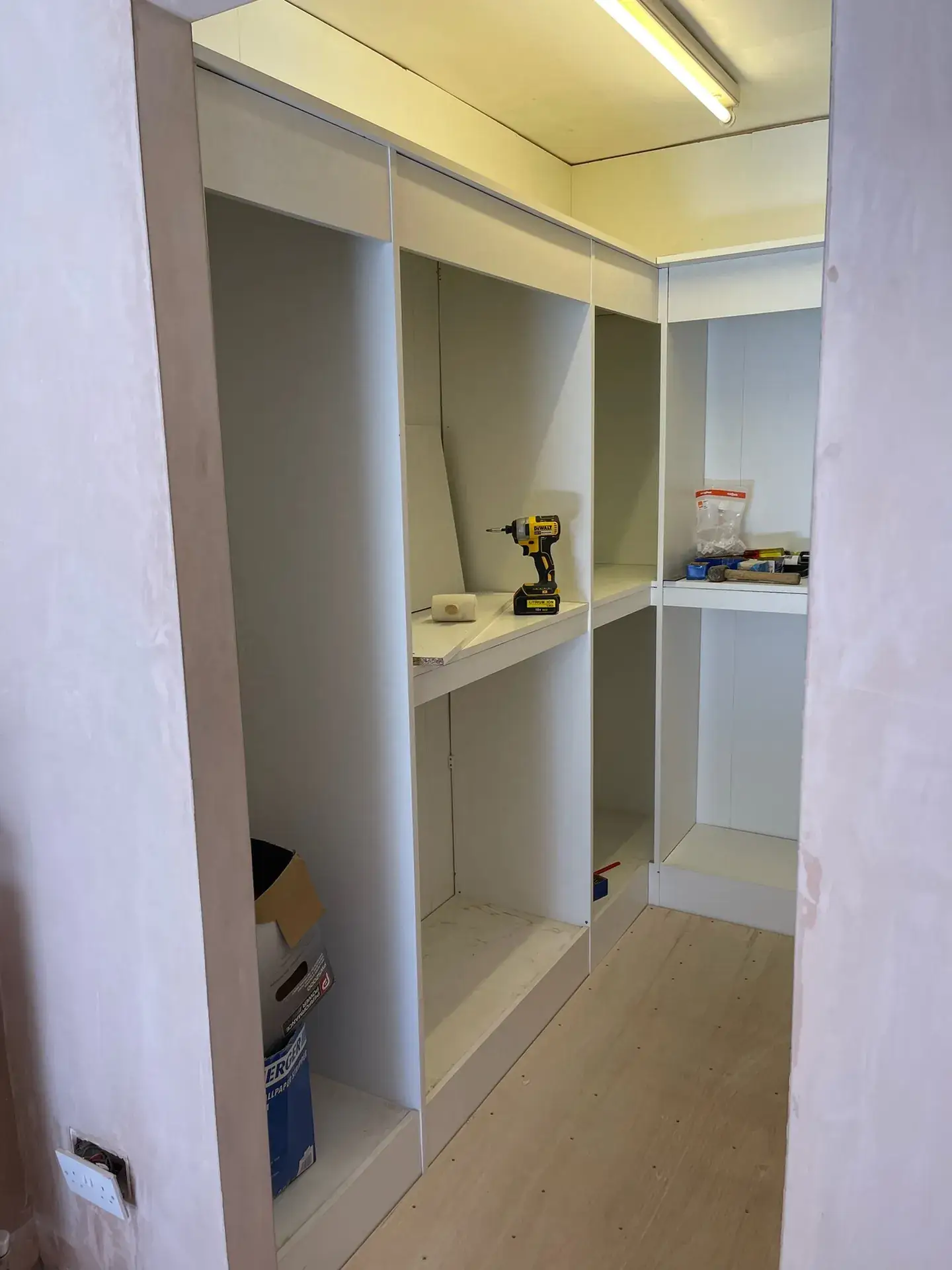 Built-in alcove shelving and hanging space, painted white
